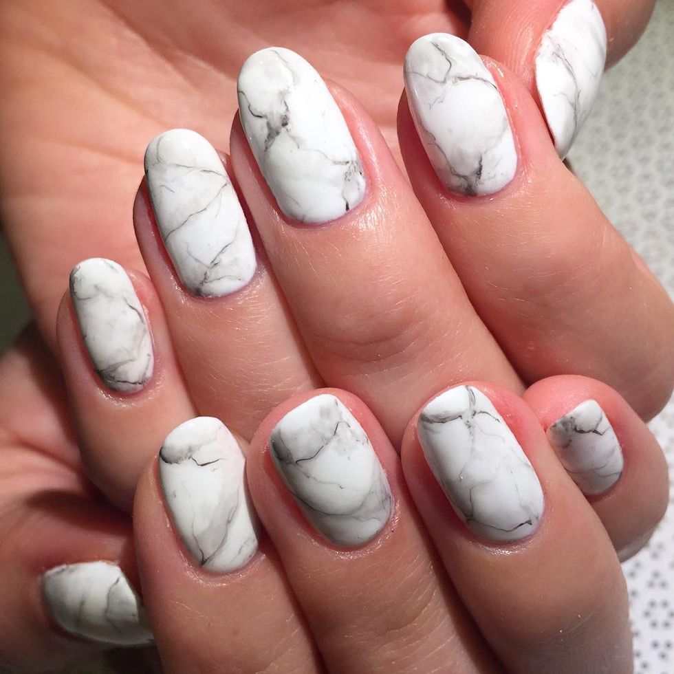 <p>Instead of creating <a href="http://www.elle.com/beauty/makeup-skin-care/g28499/nail-art-designs-short-nails/" target="_blank">tie dyed nails</a> in bright neon, choose a realistic Carrera marble design. You can follow the same steps as a traditional marbled nail, or you can freeform the design by hand. Either way, use a paintbrush dipped in polish remover to gently blur the edges. Finish with a matte topcoat and voila, you're matching your kitchen tabletop. </p><p>Design by <a href="https://www.instagram.com/p/9ugEk4jOWq/" target="_blank">rosebnails</a><br></p>