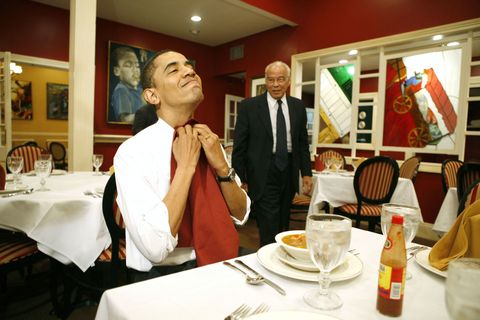 <p>Tucking in his napkin during his visit at Dooky Chase restaurant in New Orleans in 2008</p>