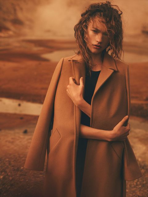 Brown, Fashion model, Beige, Flash photography, Long hair, Vintage clothing, Overcoat, Costume, Fashion design, Day dress, 