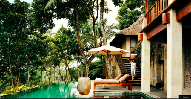 Tree, Resort, Shade, Arecales, Outdoor furniture, Palm tree, Tropics, Eco hotel, Outdoor structure, Umbrella, 