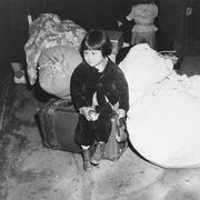 Japanese girl waits to be evacuated to a camp