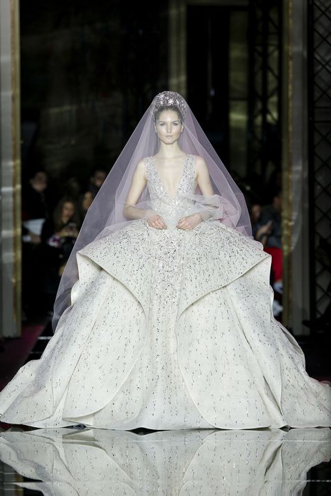 Bridal veil, Bridal clothing, Veil, Wedding dress, Dress, Gown, Bride, Bridal accessory, Embellishment, Sculpture, 
