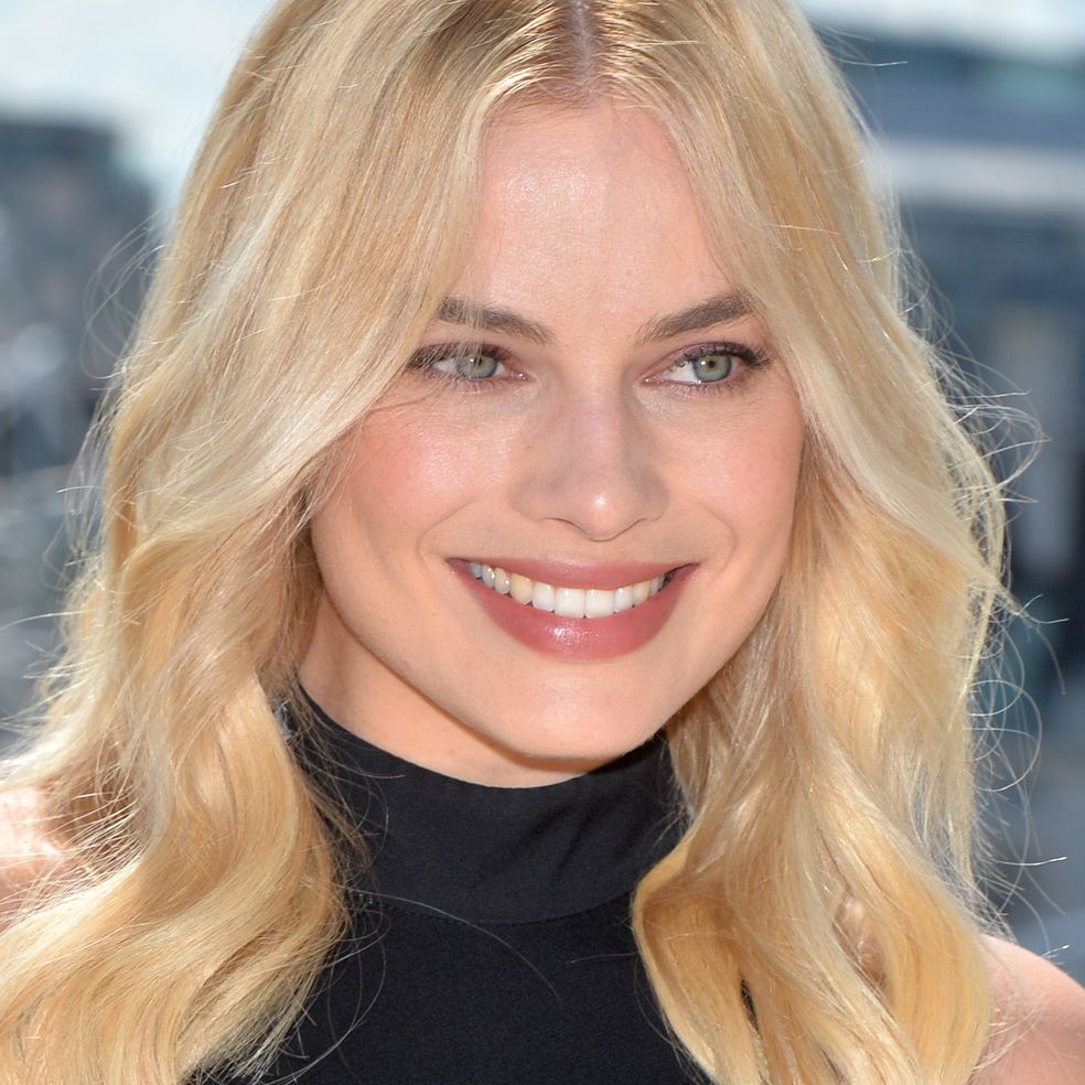 Margot Robbie Pairs Nothing But a Bra and Chain-Link Vest With Her Bell-Bottom Jeans