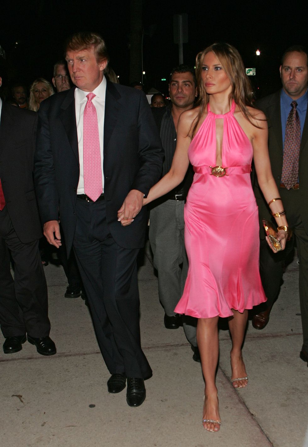 Donald Trump and Melania Trump make their way on Ocean Drive to Casa Casuarina on March 4, 2005 in Miami Beach, Florida