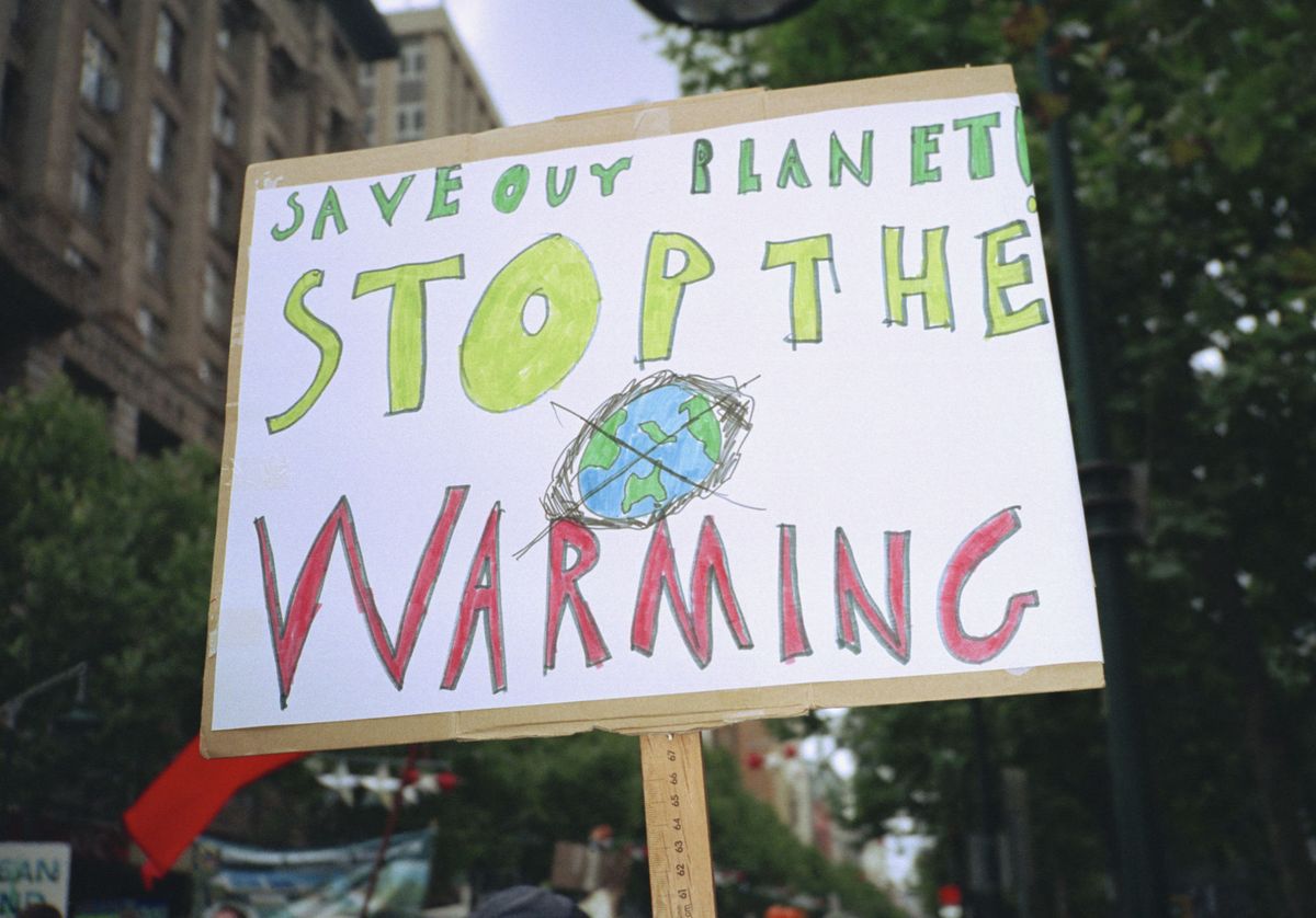 Close-up of global warming sign in city