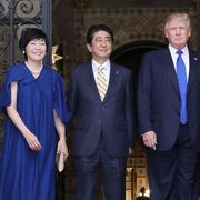 US President Donald Trump (centre R), Japans Prime Minister Shinzo Abe (centre L), Trump's wife Melania (R) and Abe's wife Akie (L) pose for photograpers before a dinner party in Palm Beach, Florida on February 11, 2017.