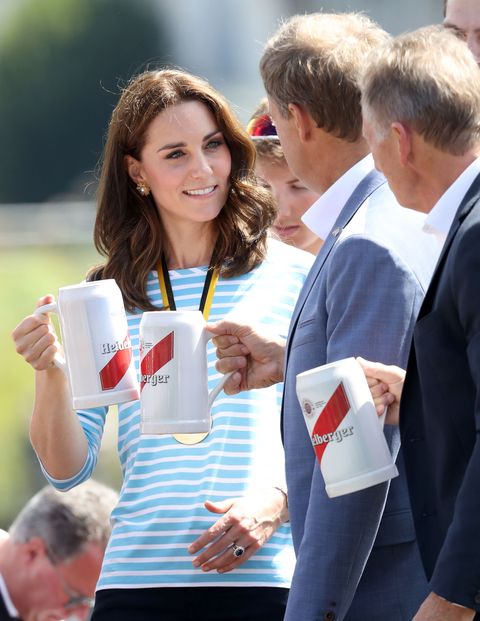 Catherine, Duchess of Cambridge celebrates with a beer after participating in a rowing race between the twinned town of Cambridge and Heidelberg and against Prince William, Duke of Cambridge.