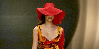 Clothing, Hat, Shoulder, Dress, Red, Fashion show, One-piece garment, Fashion model, Headgear, Fashion accessory, 