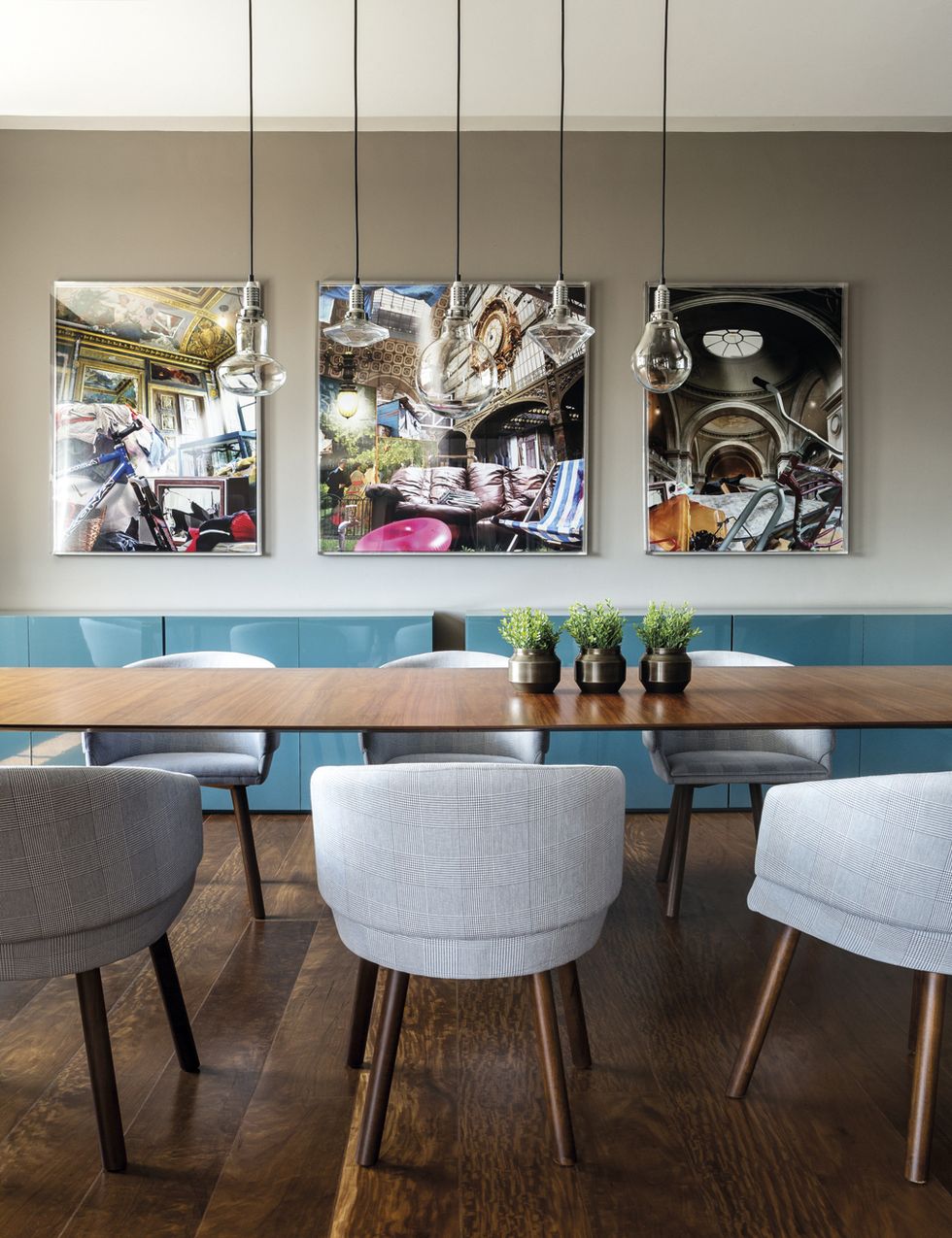 <p>No pueden llevarse mejor la madera y el azul turquesa del aparador, firmado por Triplex Arquitectura. La mesa es un precioso diseño de Arquivo Contemporâneo, con sillas de Catallogo. Los cuadros del artista Lúcio Carvalho llenan con su intensidad el espacio.&nbsp;</p>