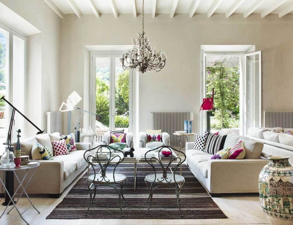 <p>En permanente conexión con el jardín, el salón se ha decorado con un mix de estilos: los sofás son de Flexform; las butacas <i>LC2</i> son un diseño de Le Corbusier para Cassina; las lámparas  de pie <i>Tizio,</i> de Artemide; las sillas francesas de anticuario y la alfombra turca, de A Casa Bianca.</p>