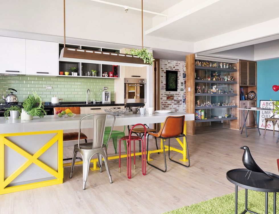 <p>La cocina, equipada con un mobiliario en MDF hecho a medida, el despacho y el salón se organizan en un mismo ambiente. En la zona de cocción, las paredes se protegen con unos azulejos verdes <i>made in Spain</i>, adquiridos en Cheng Feng. El horno es de la firma Bosch.</p>