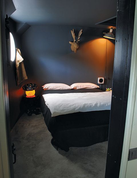 Los propietarios tuvieron que dar siete capas de pintura para conseguir el tono exacto que querían en este dormitorio. Sobre la cama,  cabeza de alce realizada con virutas de madera de la tienda Le Bout du Monde (en Rennes).
