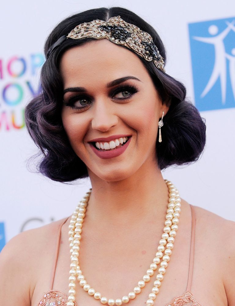 <p><strong>Katy Perry</strong> opta por un look al más puro estilo 'flapper', con perlas y diadema decorada sobre un bob con ondas. Nos encanta su maquillaje en tonos oscuros y labios mate. </p>