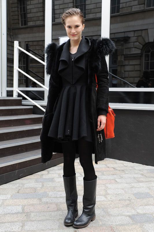 <p>Ella rompe un total look negro con un bolso llamativo en color rojo. Nos encanta su vestido con volúmenes.</p>
