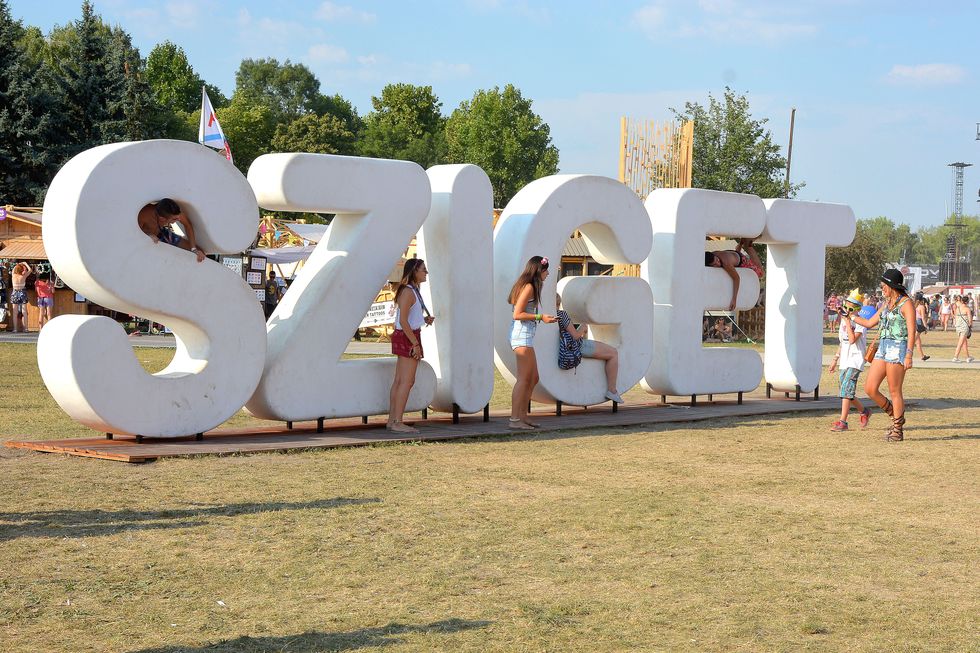 BUDAPEST, HUNGARY - AUGUST 12:  Music fans take pictures at the 'SZIGET' sign at Sziget Festival 2015 at Obudai Island on August 12, 2015 in Budapest, Hungary.  (Photo by Didier Messens/Redferns)