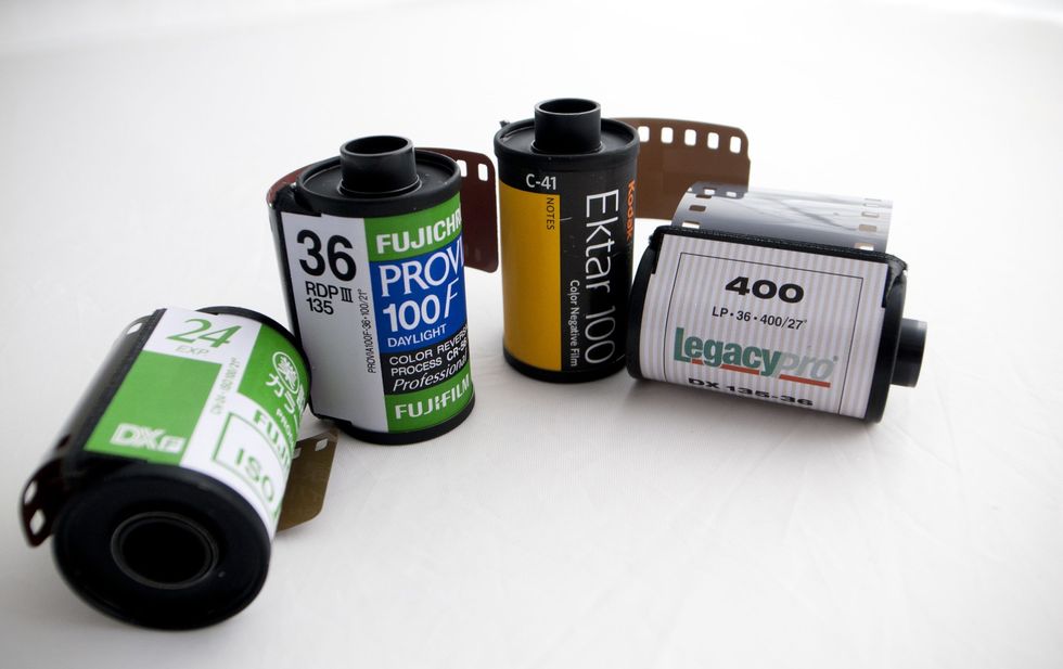 Product, Green, Camera accessory, Logo, Font, Plastic, Photographic film, Brand, Paint, Cylinder, 