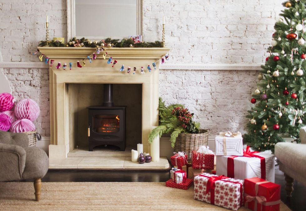 Living room, Christmas decoration, Room, Christmas stocking, Home, Fireplace, Christmas tree, Hearth, Interior design, Property, 