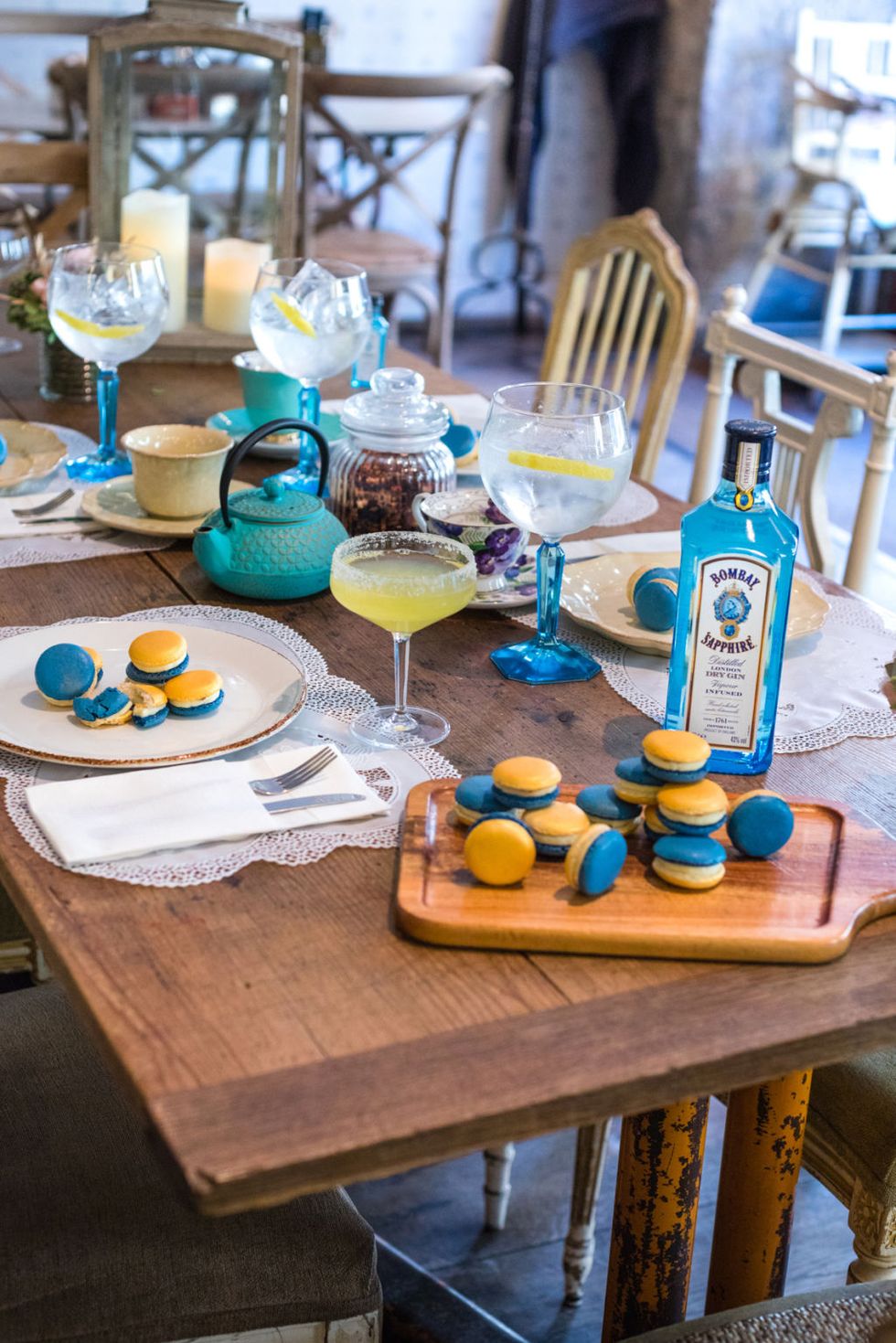 Table, Turquoise, Yellow, Furniture, Brunch, Room, Interior design, Liqueur, Drink, Coffee table, 