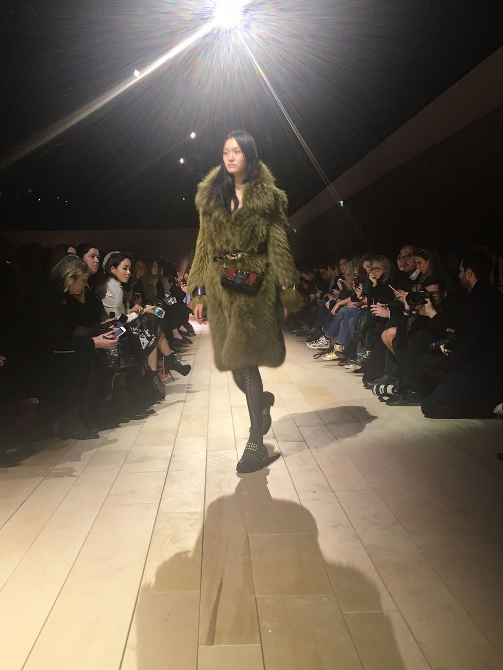 Fashion show, Outerwear, Military camouflage, Runway, Camouflage, Jacket, Fashion model, Fashion, Public event, Military, 