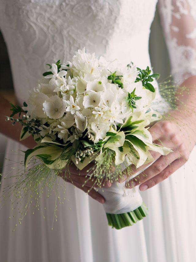 Petal, Finger, Bouquet, Bridal clothing, Wedding dress, Textile, Photograph, Dress, Joint, White, 