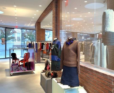 Retail, Glass, Mannequin, Display window, Boutique, Outlet store, Sweater, Commercial building, Shelf, Display case, 