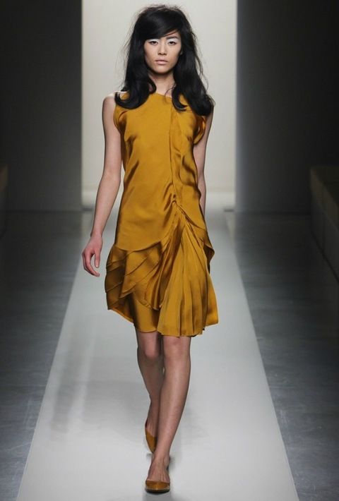 Clothing, Brown, Hairstyle, Yellow, Sleeve, Human leg, Shoulder, Fashion show, Joint, Dress, 