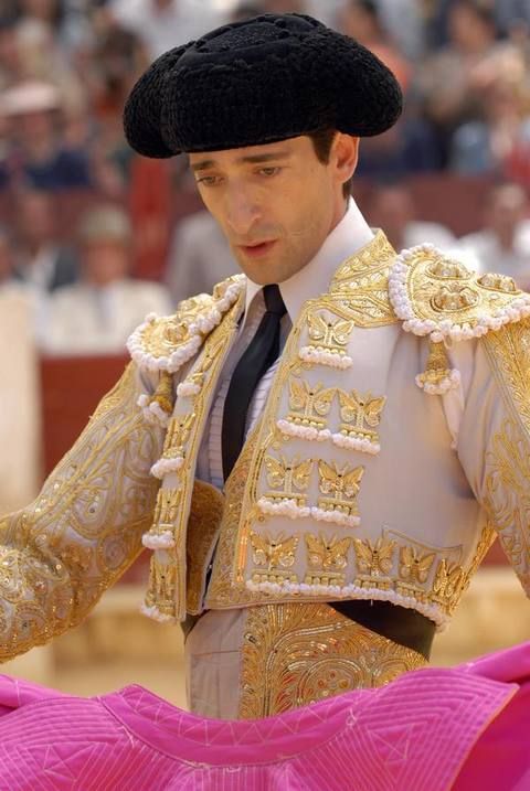 Matador, Tradition, Headgear, Performance, Costume accessory, Bullring, Bullfighting, Costume design, Fur, Fashion design, 