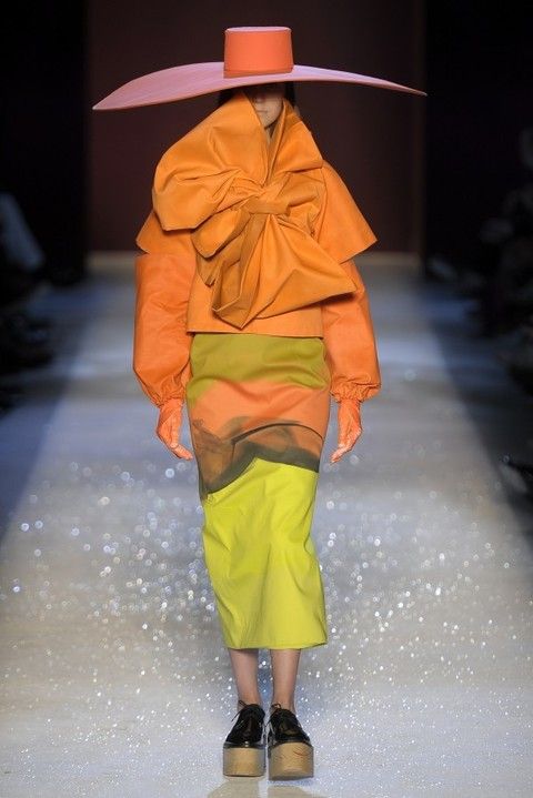 Hat, Human leg, Orange, Fashion, Sun hat, Raincoat, Rain suit, Costume design, Costume accessory, Peach, 