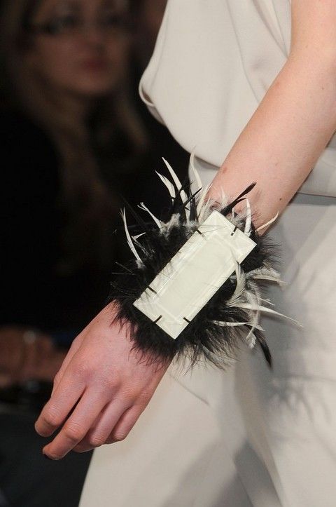 Human, Finger, Wrist, Nail, Feather, Fashion design, Glove, Natural material, Bracelet, 