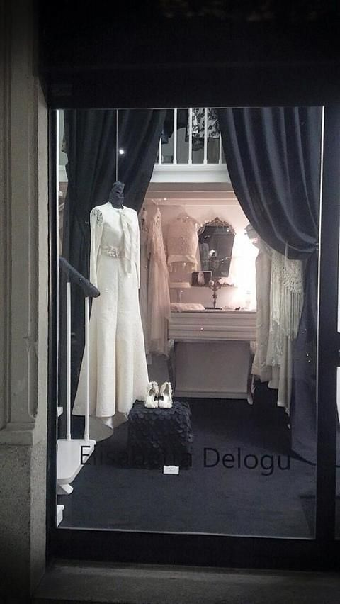 Dress, Textile, Interior design, Mannequin, Window treatment, Curtain, One-piece garment, Boutique, Display window, Wedding dress, 