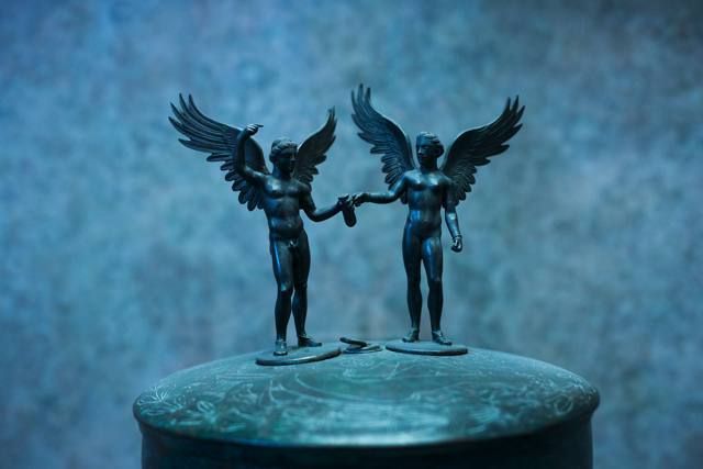 Sculpture, Wing, Fictional character, Metal, Supernatural creature, Angel, Mythical creature, Statue, Figurine, Cylinder, 
