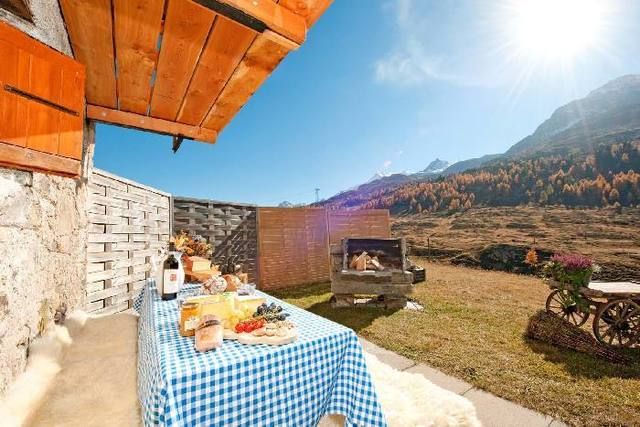 Tablecloth, Table, Linens, Home accessories, Lens flare, Animation, Sun, Outdoor table, Outdoor furniture, Stone wall, 