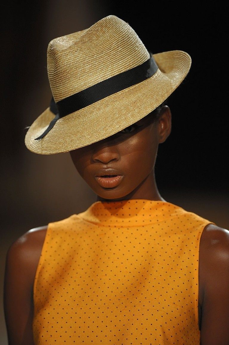 Clothing, Hat, Lip, Brown, Yellow, Chin, Shoulder, Fashion accessory, Style, Headgear, 
