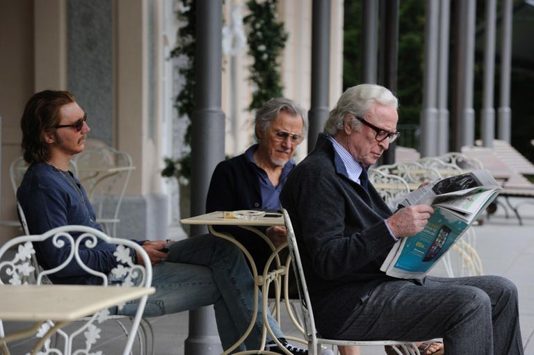 Face, Glasses, Sitting, Suit trousers, Reading, Houseplant, Outdoor furniture, 