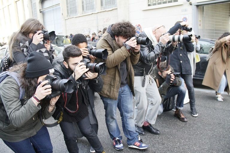 Camera, Jacket, Mammal, Jeans, Cameras & optics, Photographer, Journalist, Lens, Video camera, Camera operator, 