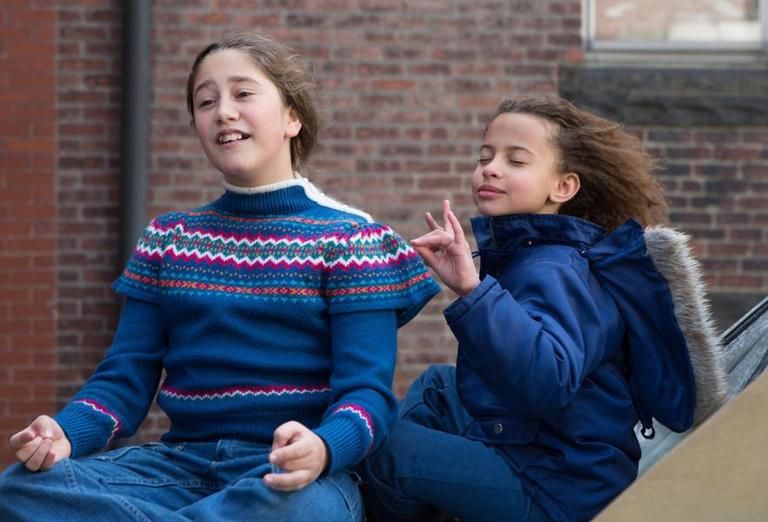 Brick, Sitting, Happy, Sweater, Jacket, Denim, Brickwork, Street fashion, Brown hair, Lap, 