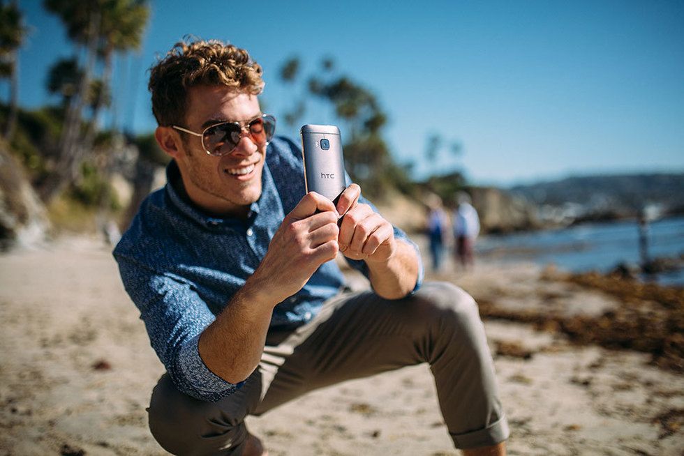 Hand, Mobile phone, Vacation, Shore, Portable communications device, Travel, Sand, Sunglasses, Beach, Goggles, 