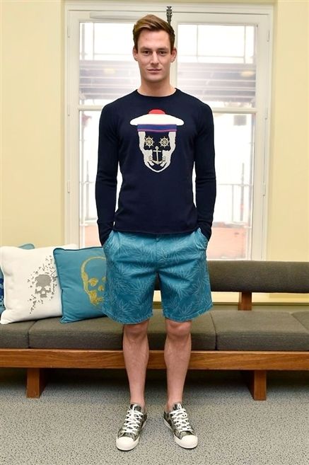 Blue, Sleeve, Shoulder, Human leg, Textile, Shoe, Standing, Style, Throw pillow, Shorts, 