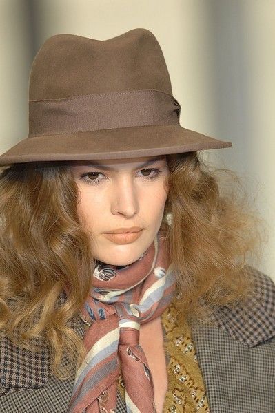 Clothing, Lip, Hat, Brown, Hairstyle, Chin, Collar, Fashion accessory, Style, Coat, 