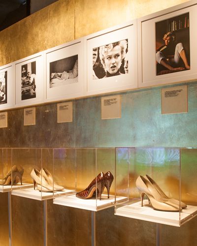 High heels, Tan, Art, Picture frame, Collection, Museum, Tourist attraction, Outdoor shoe, Visual arts, Art exhibition, 