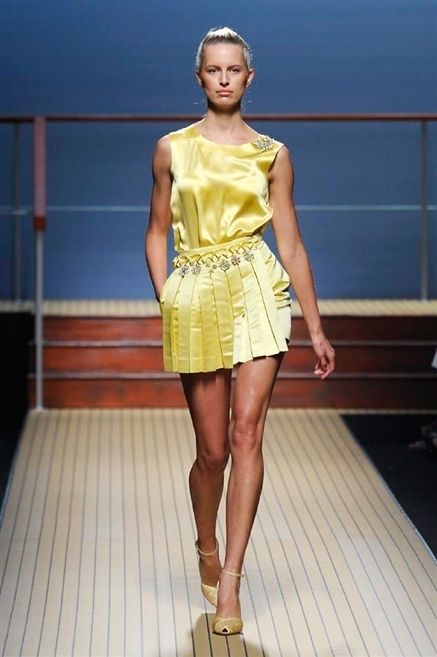 Yellow, Human leg, Shoulder, Dress, Joint, Fashion show, Waist, One-piece garment, Style, Knee, 