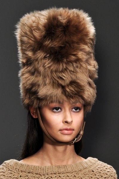 Lip, Brown, Hairstyle, Textile, Headgear, Fur clothing, Costume accessory, Natural material, Fashion, Liver, 