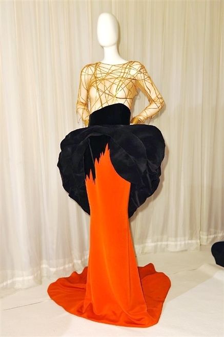 Shoulder, Joint, Mannequin, Style, Orange, One-piece garment, Neck, Back, Waist, Costume design, 