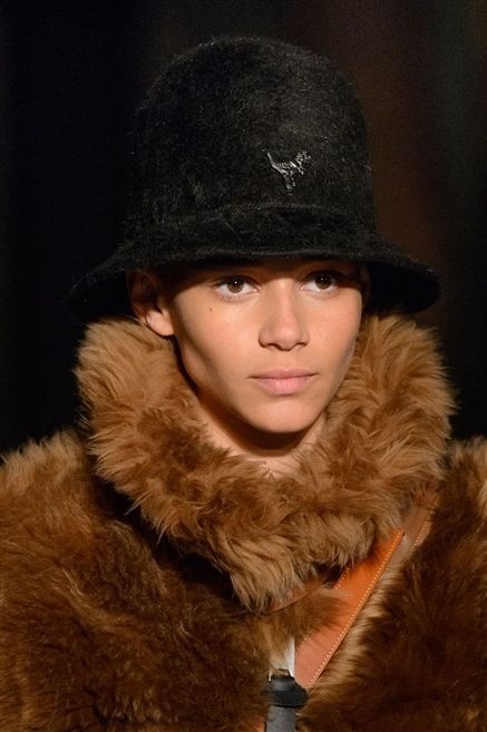 Clothing, Lip, Brown, Jacket, Hat, Textile, Fur clothing, Winter, Headgear, Natural material, 