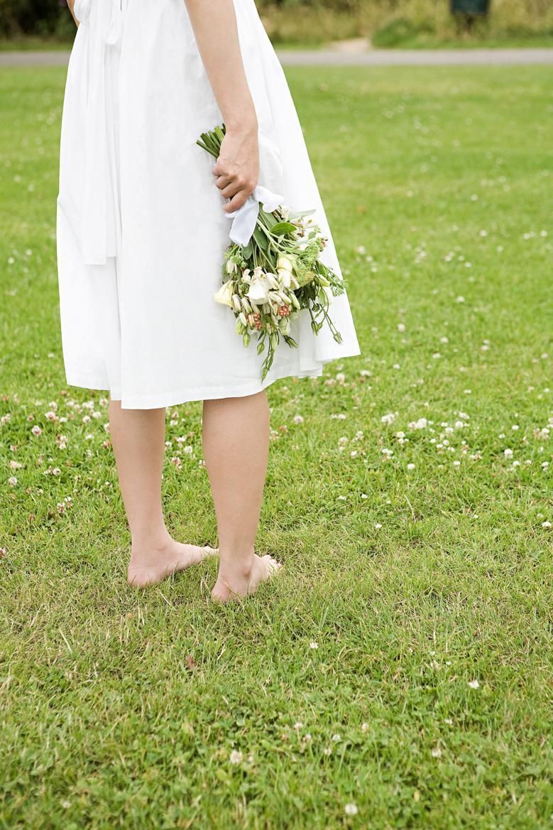 Clothing, Grass, People in nature, Petal, Dress, Foot, Spring, Beige, Barefoot, Toe, 