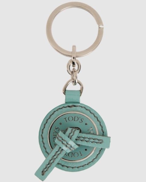 Symbol, Metal, Circle, Teal, Material property, Keychain, Medal, Body jewelry, Chain, 
