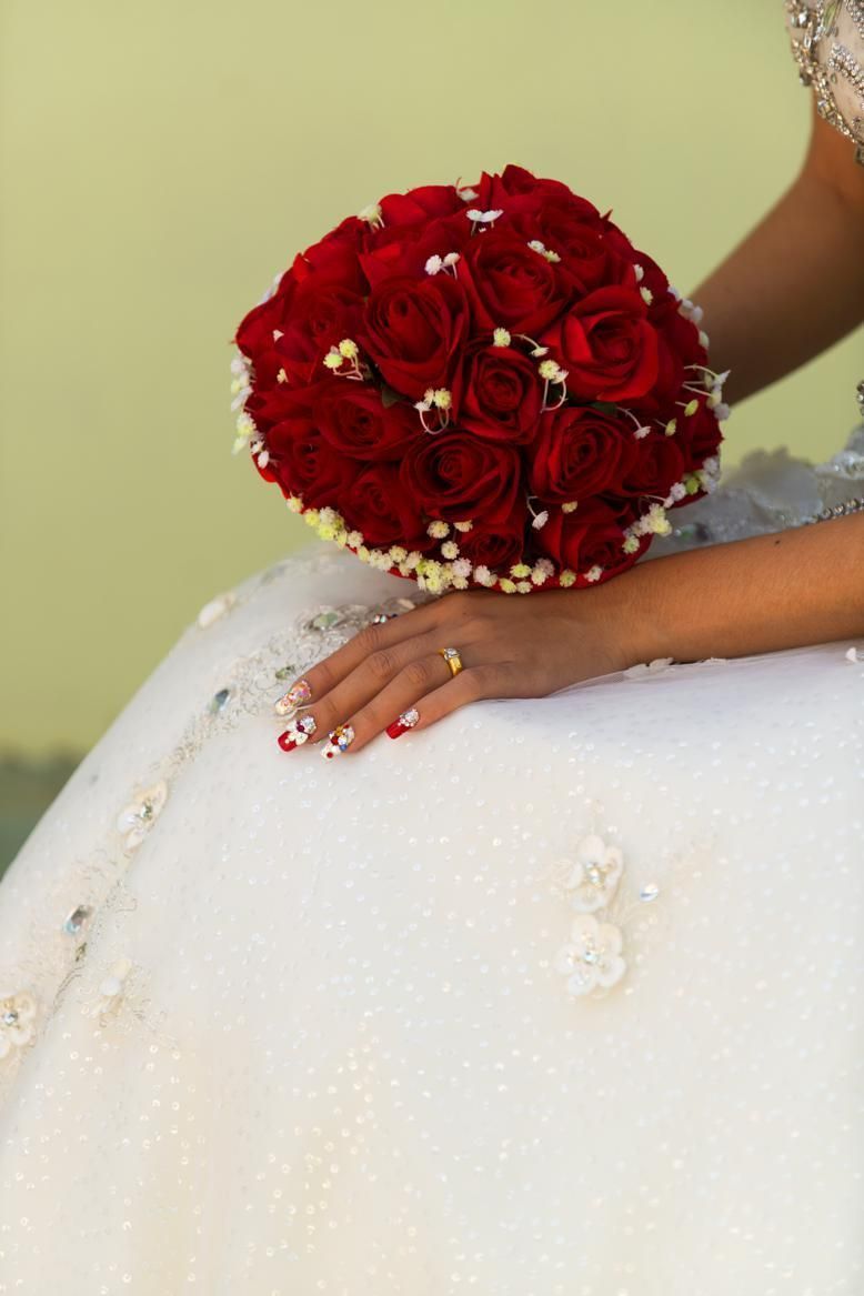 Finger, Petal, Wrist, Red, Bouquet, Flower, Cut flowers, Bridal clothing, Fashion accessory, Wedding dress, 
