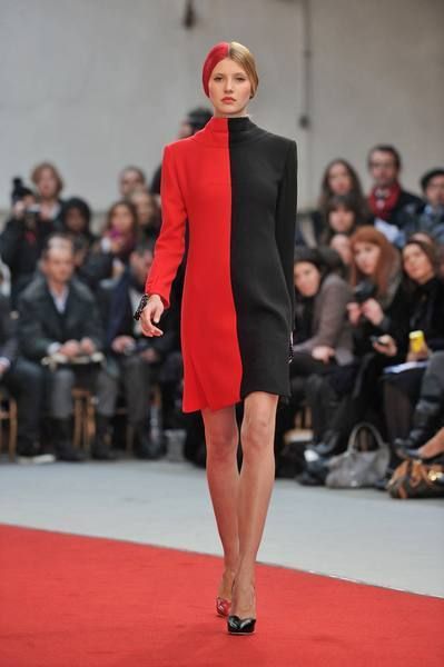 Lip, Fashion show, Event, Shoulder, Runway, Red, Joint, Outerwear, Flooring, Fashion model, 