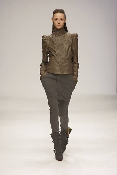 Clothing, Brown, Human body, Sleeve, Fashion show, Shoulder, Textile, Joint, Outerwear, Standing, 