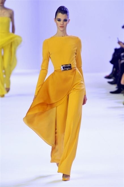 Yellow, Hairstyle, Fashion show, Sleeve, Shoulder, Joint, Runway, Standing, Waist, Formal wear, 